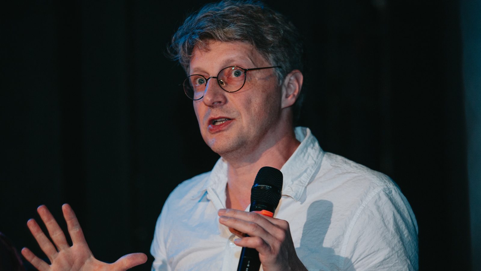 Dmitry Borisenko with a microphone at the round table